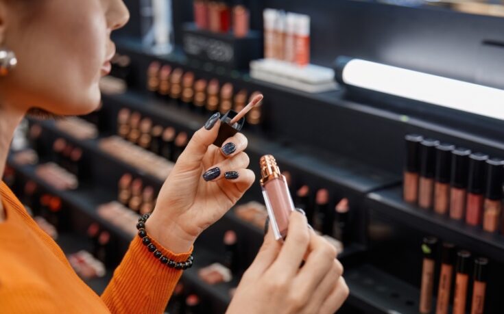 woman applying cosmetics in a store